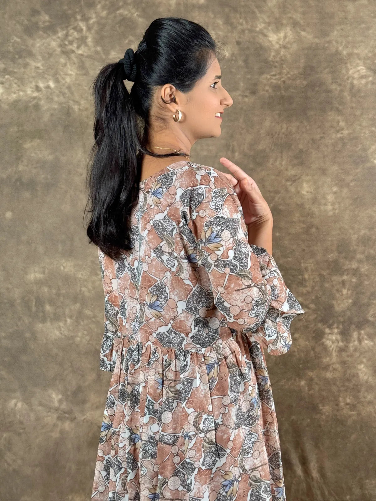 Tarani brown georgette midi dress back side view with flowing design