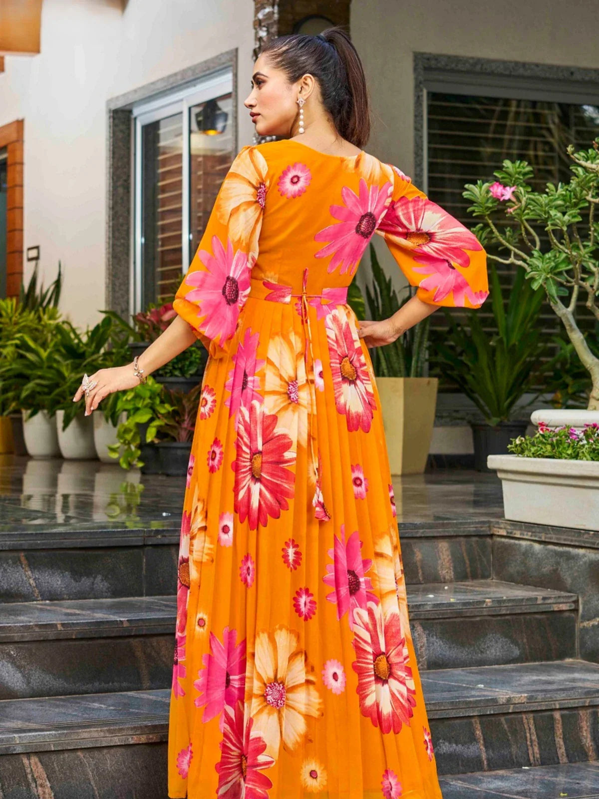 Tarani orange georgette dress with floral print in back view worn by model