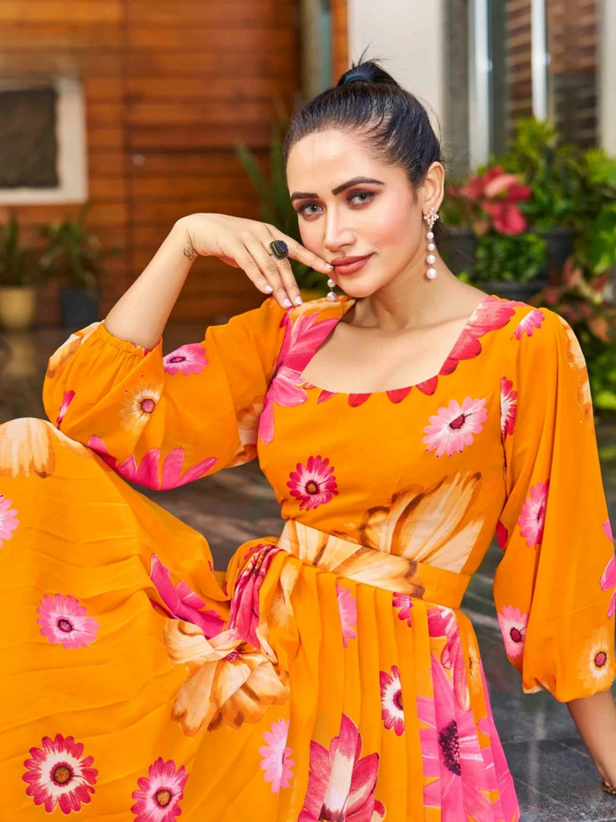 Tarani orange georgette dress with floral print in upper body view worn by model
