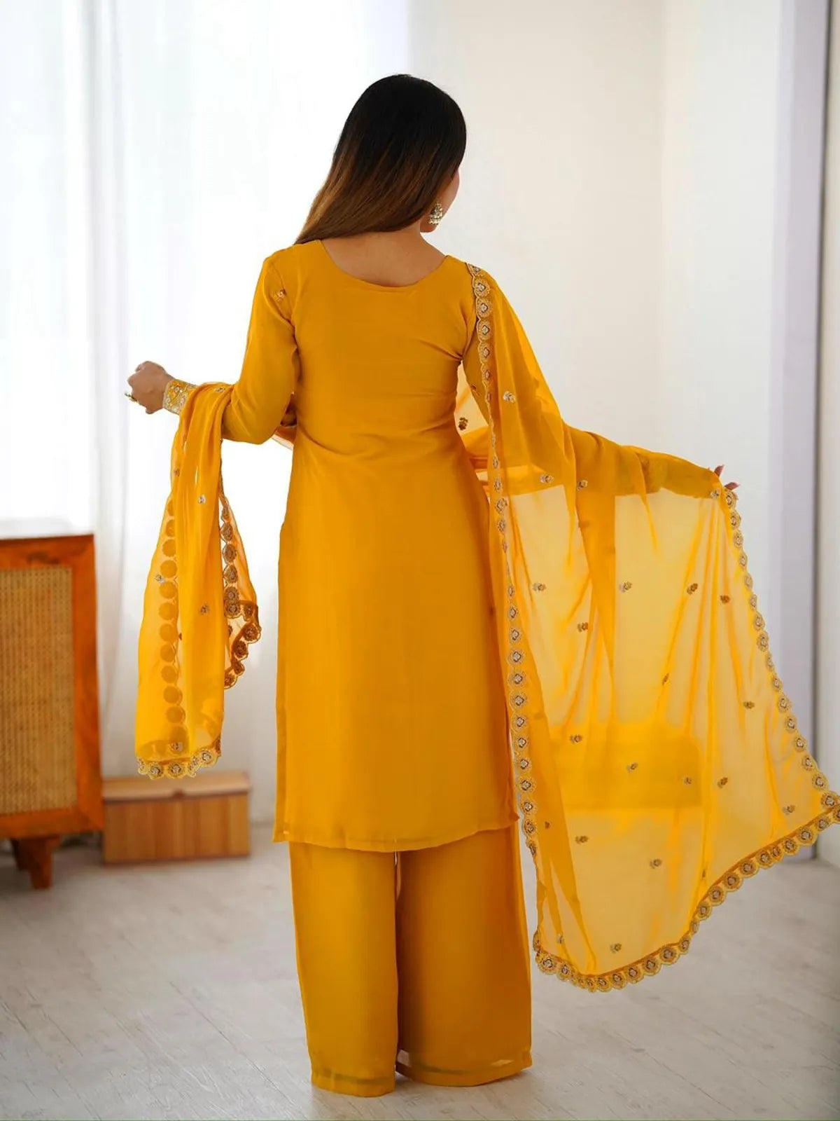 Tarani yellow georgette dress full back view with soft drape and scalloped dupatta