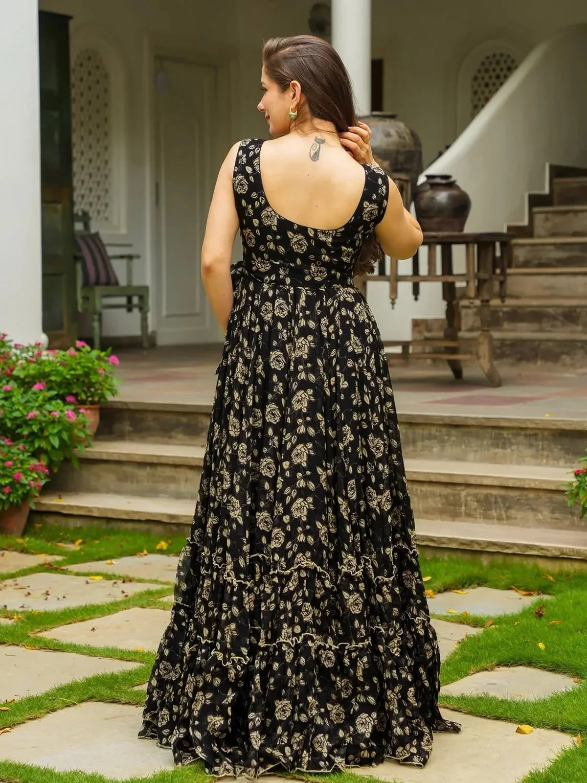 Tarani black georgette gown with golden digital floral print back design and deep cut styling