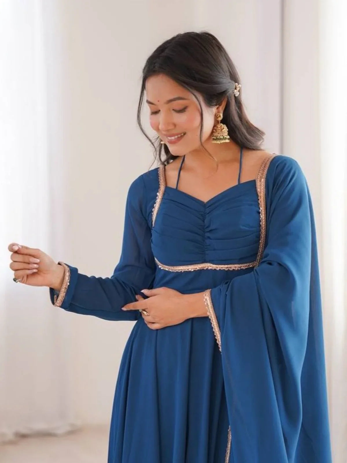 Tarani blue georgette gown with close-up yoke neckline and full sleeves for party and festive wear