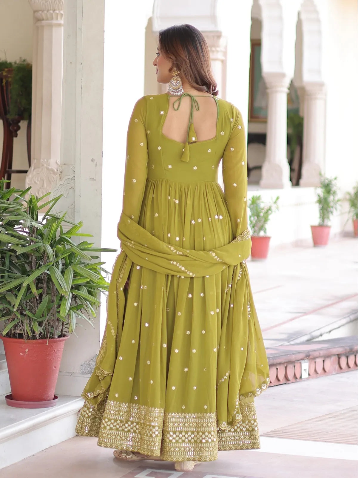 Tarani ceremonial gown back design in green with tie-up and elegant dupatta fall