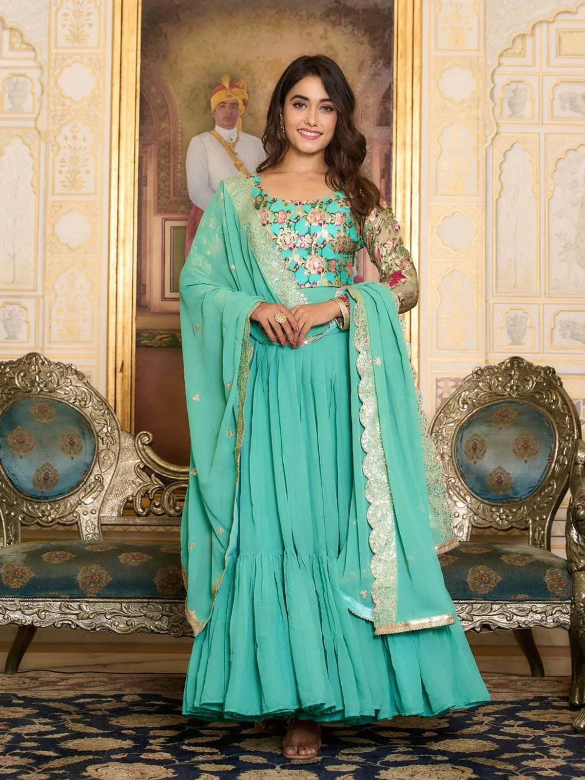 Tarani front view of green georgette gown with embroidered floral detailing and matching dupatta
