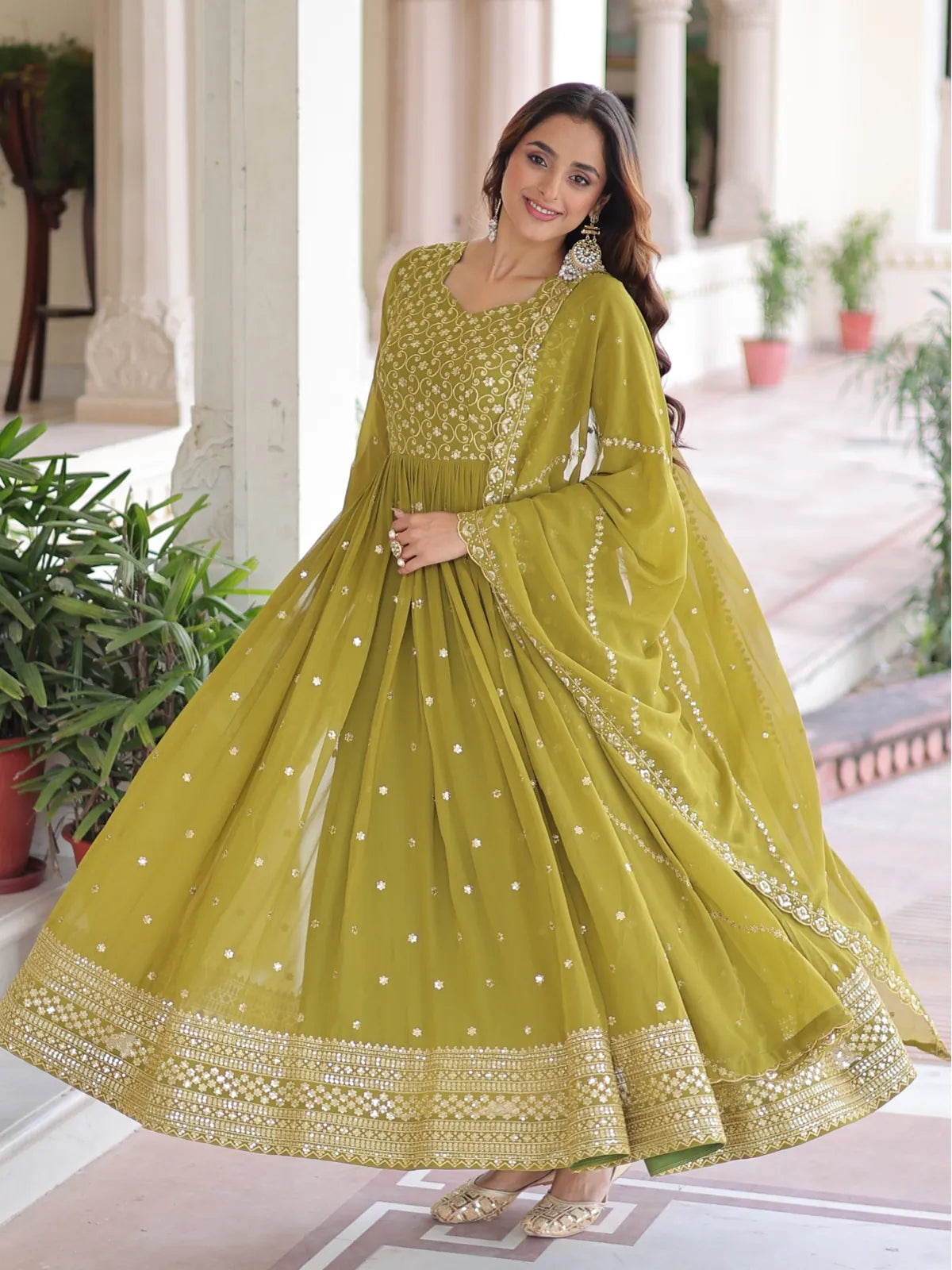 Tarani designer gown in green faux georgette with complete flare and zari highlights