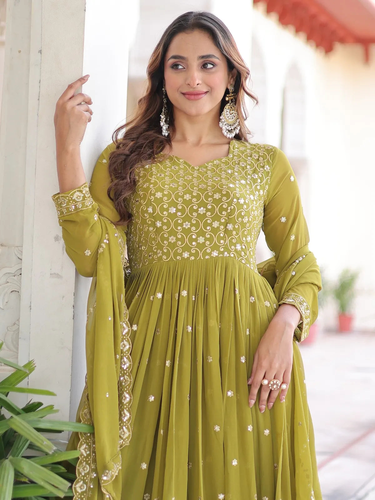 Tarani premium green party wear gown showing detailed neckline and sleeve embroidery