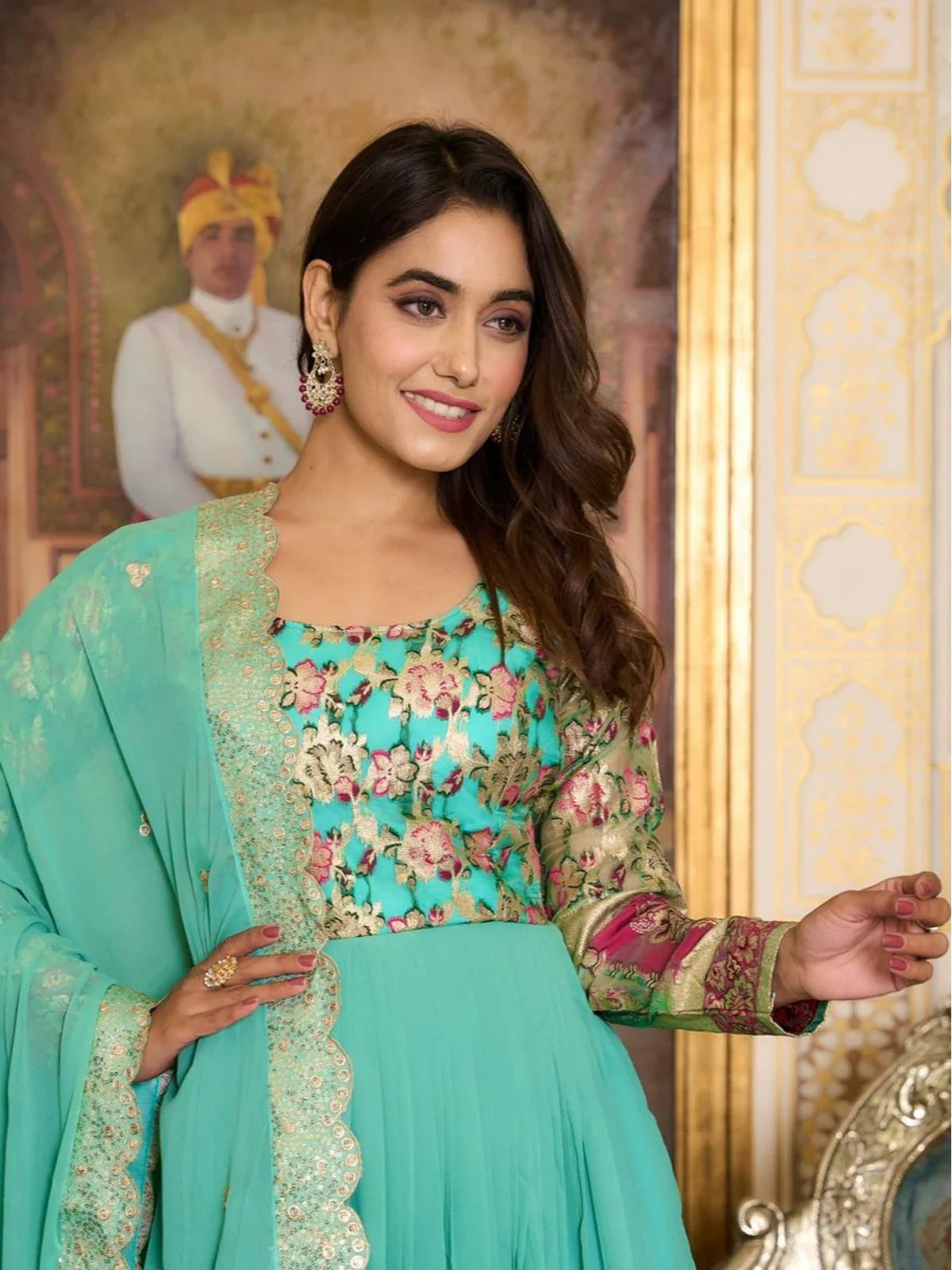 Tarani close-up showing green floral embroidery on georgette gown with scalloped dupatta border