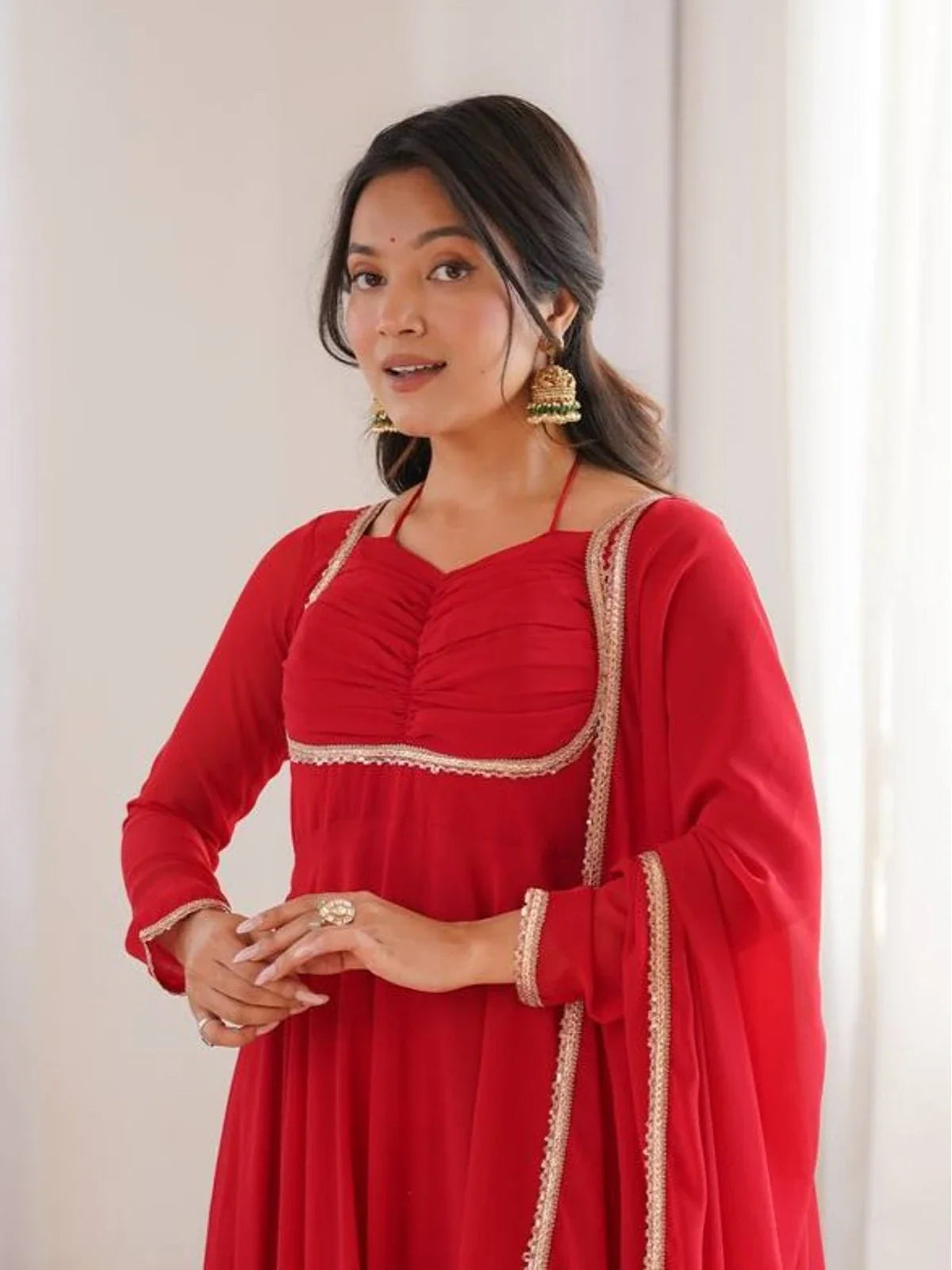 Tarani red georgette gown close-up with yoke design and sleeve embroidery