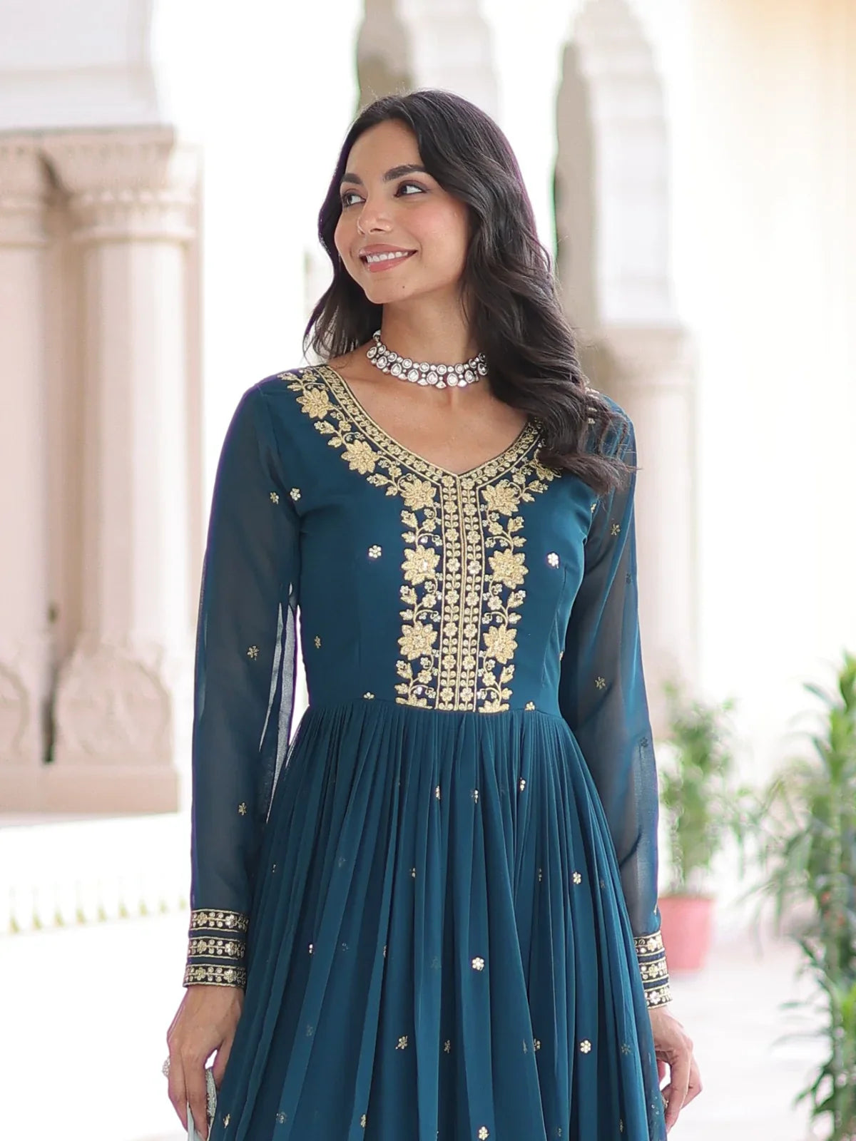 Tarani teal gown close-up showing neckline embroidery and full sleeves