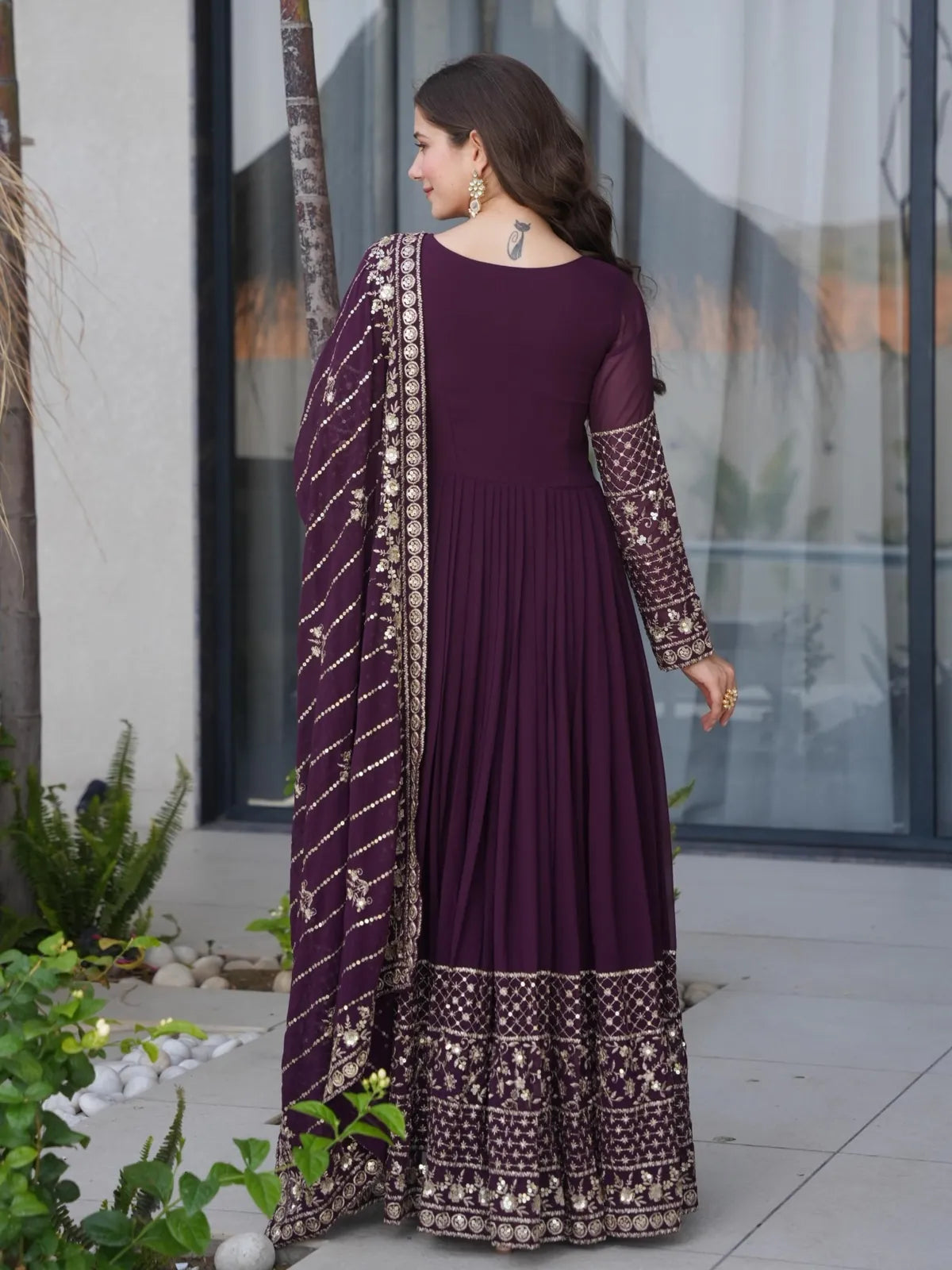 Tarani back view of wine georgette gown showing intricate embroidery with dupatta and pleated fall