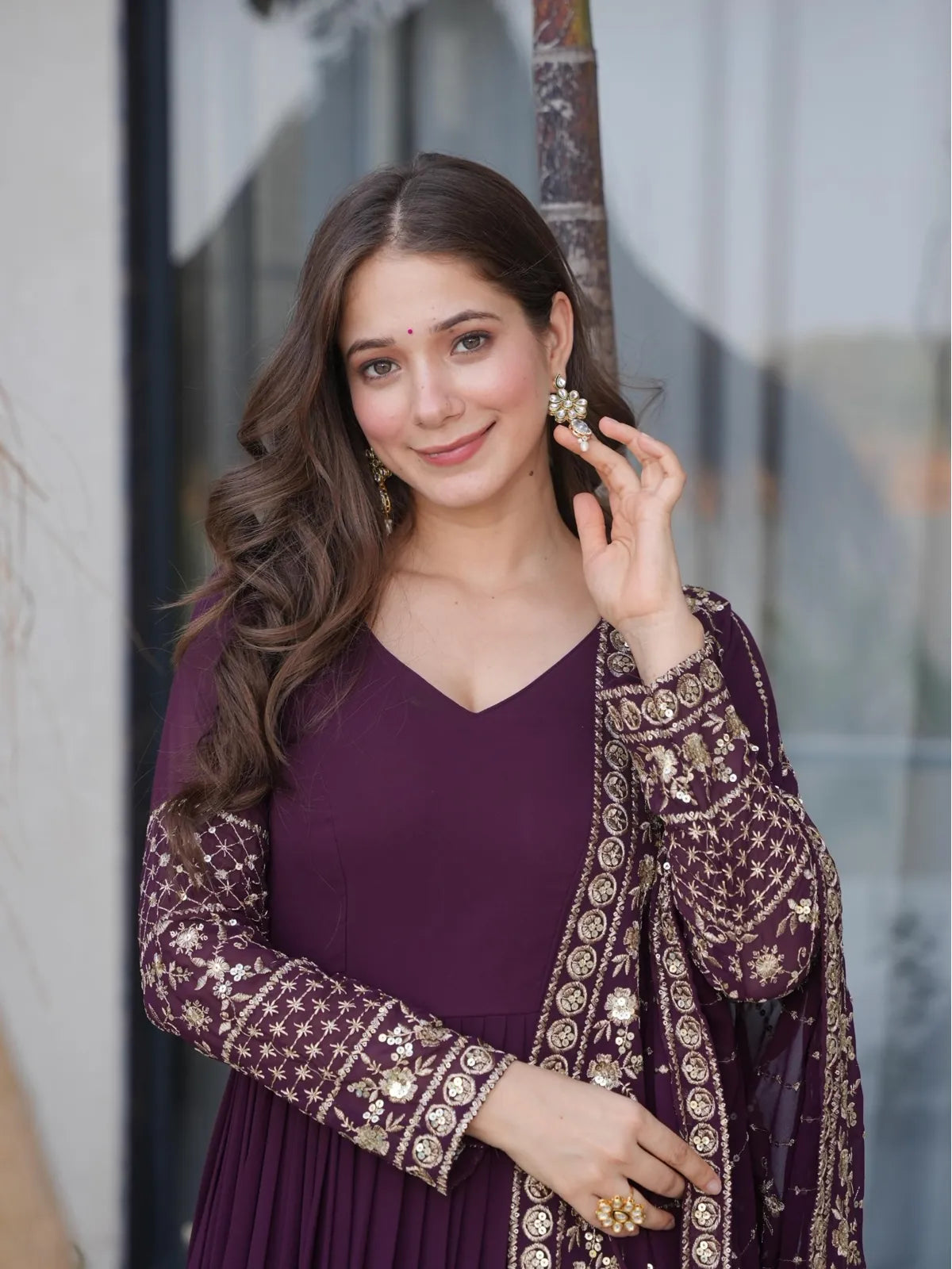 Tarani elegant embroidered wine georgette gown with rich sleeves and v-neck upper body closeup