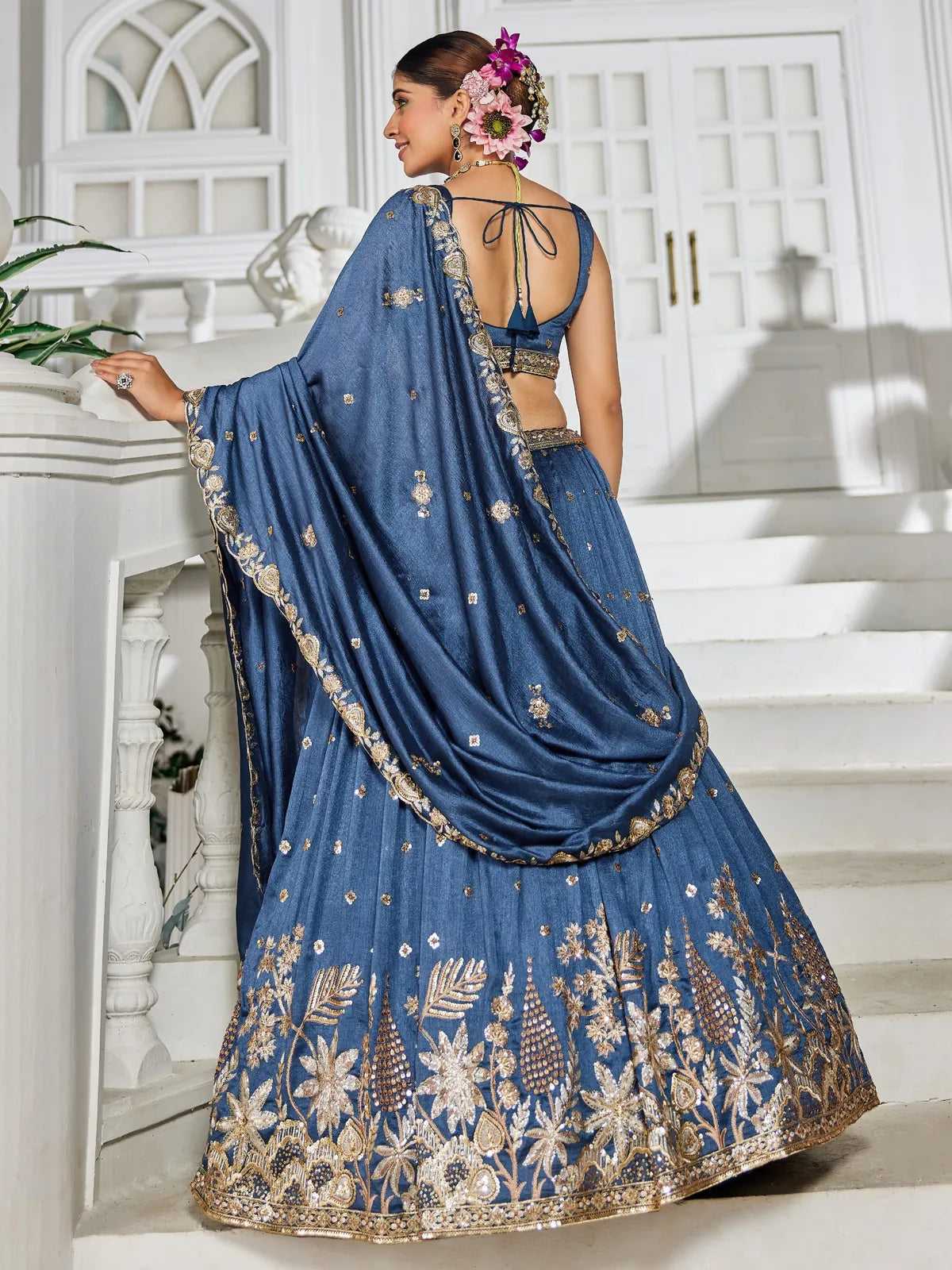 Tarani back view of blue georgette lehenga with embroidered dupatta