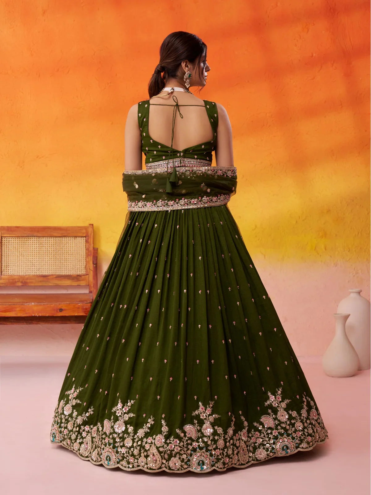 Tarani back view of bridal lehenga with tie-up blouse and flared skirt in olive green