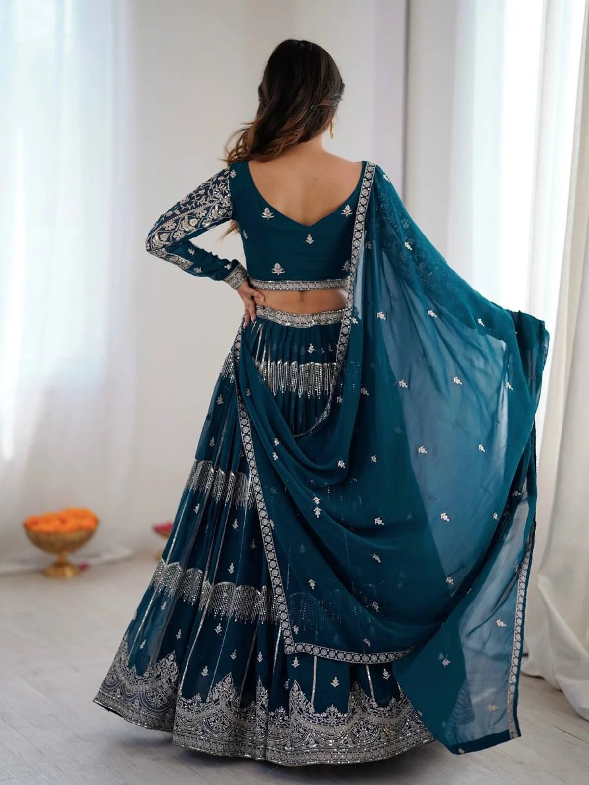 Tarani teal lehenga back view with matching dupatta drape and blouse back neckline