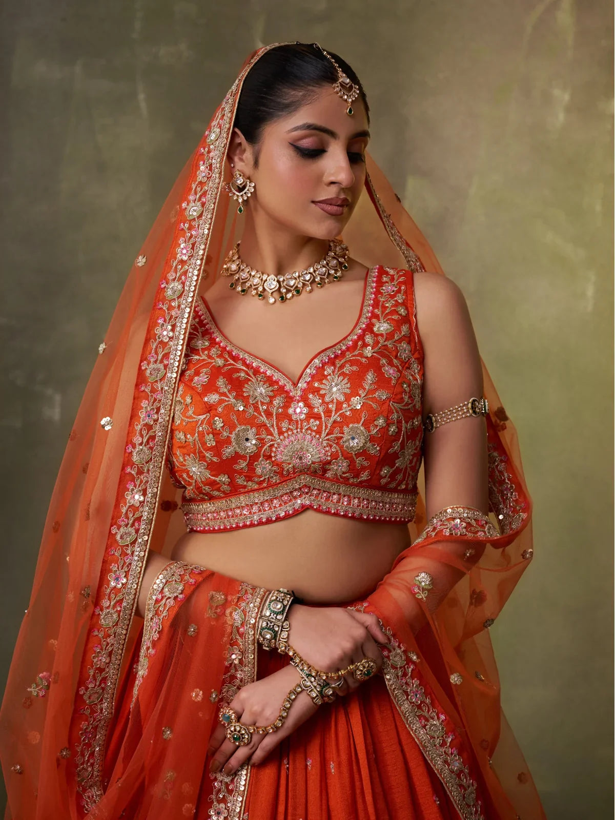 Tarani close view of orange georgette lehenga blouse with sequins and thread embroidery