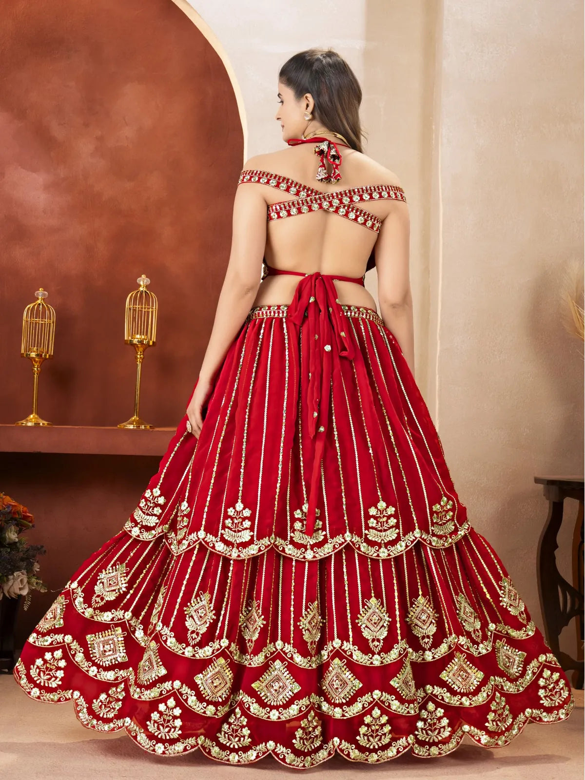 Tarani red lehenga back view with open back blouse and tie-up design