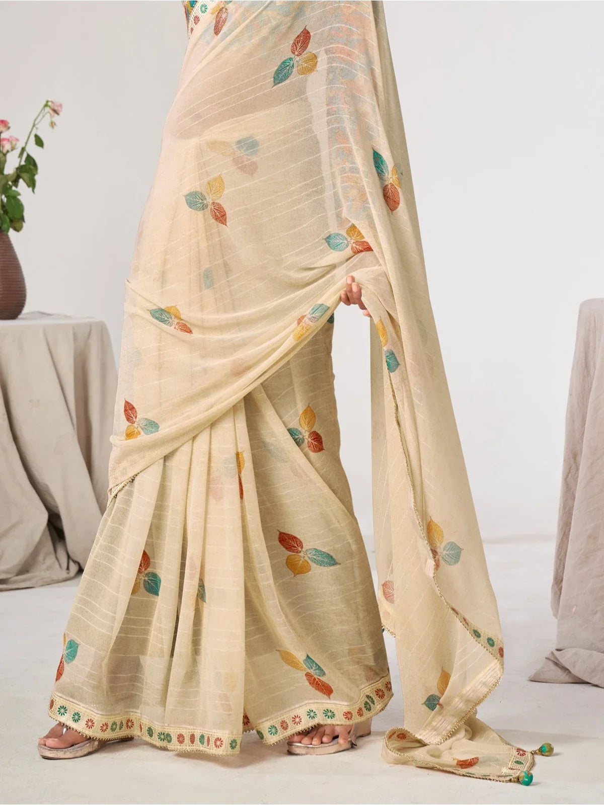 Tarani beige saree pallu view with colorful leaf embroidery and elegant border finish