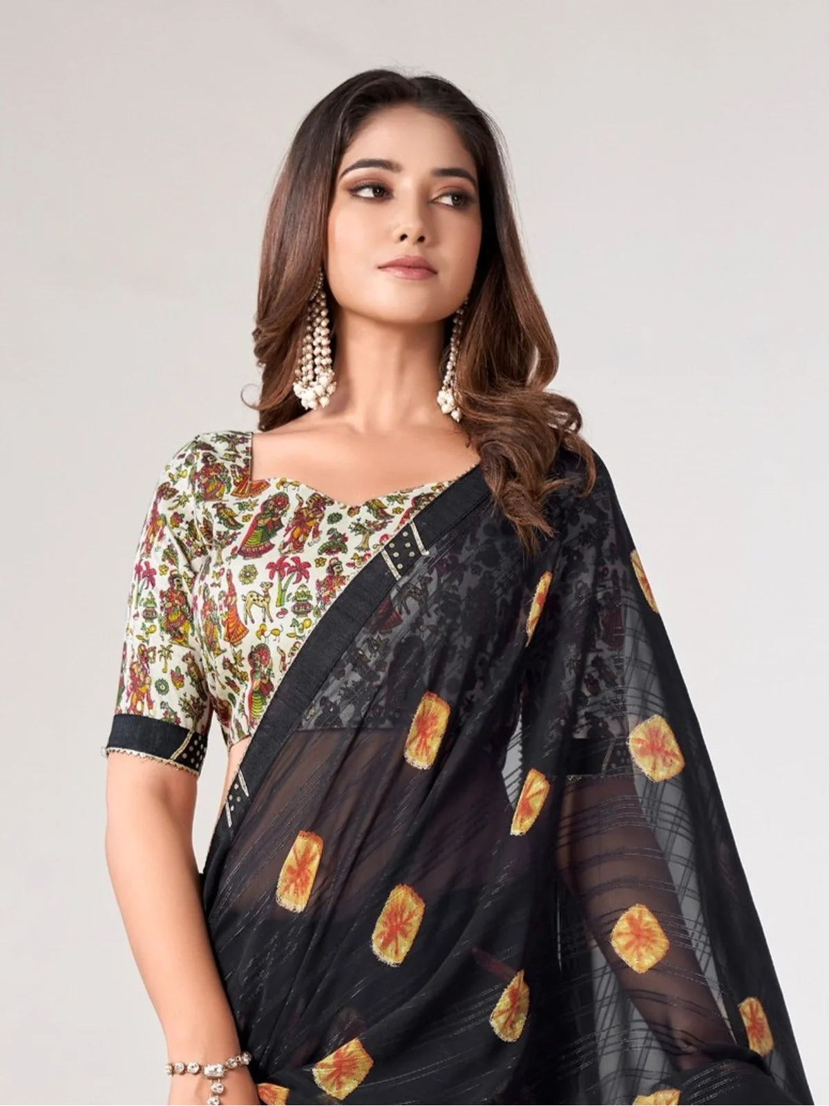 Tarani elegant black georgette saree drape showing intricate printed motifs and graceful pallu design