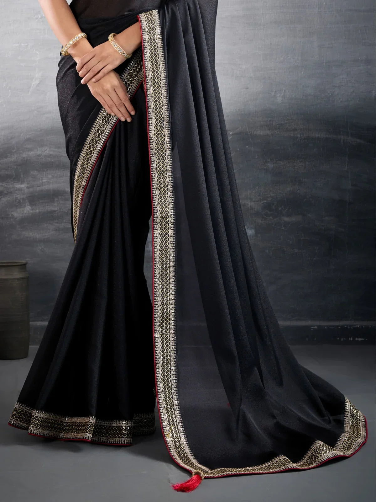 Tarani black georgette saree pallu and border detailed view with tassel finish for festive style