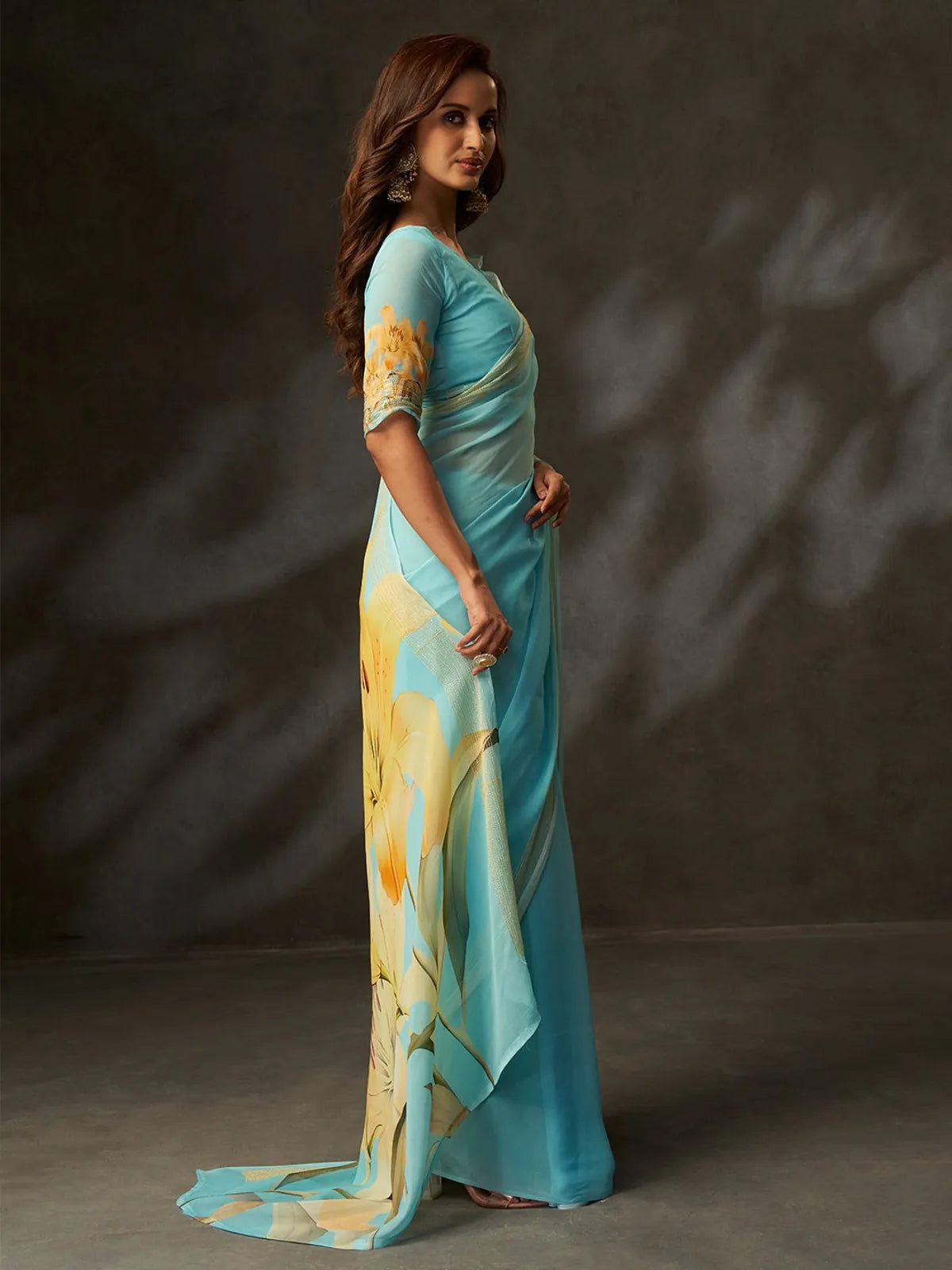 Tarani premium blue georgette saree side view with yellow floral design and matching blouse