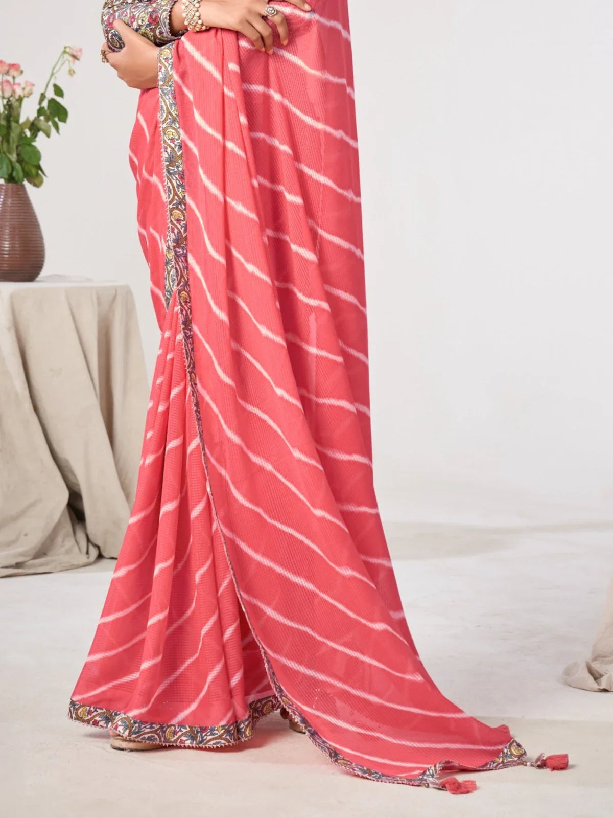 Tarani closeup view of coral pink georgette saree with printed silk-blend blouse design details
