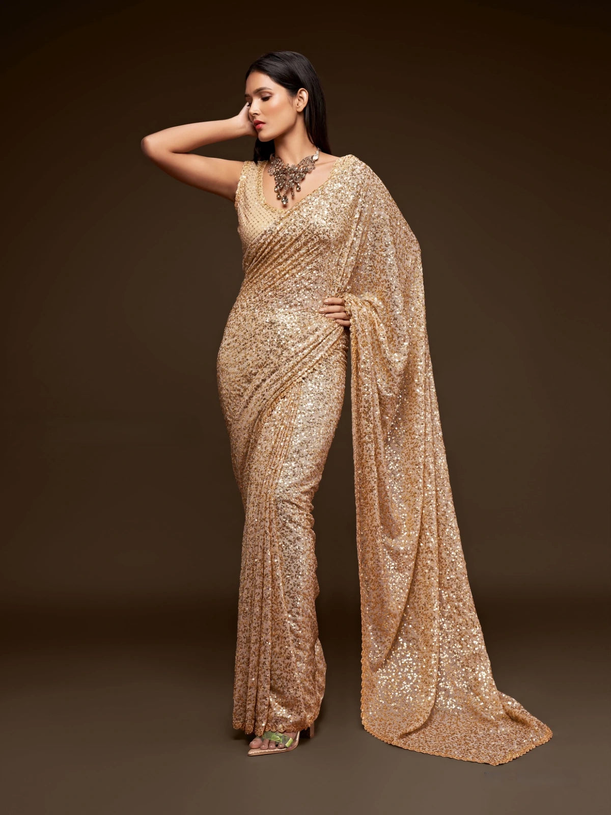 Tarani golden georgette saree side pose with elegant sequins embroidery for carnival wear