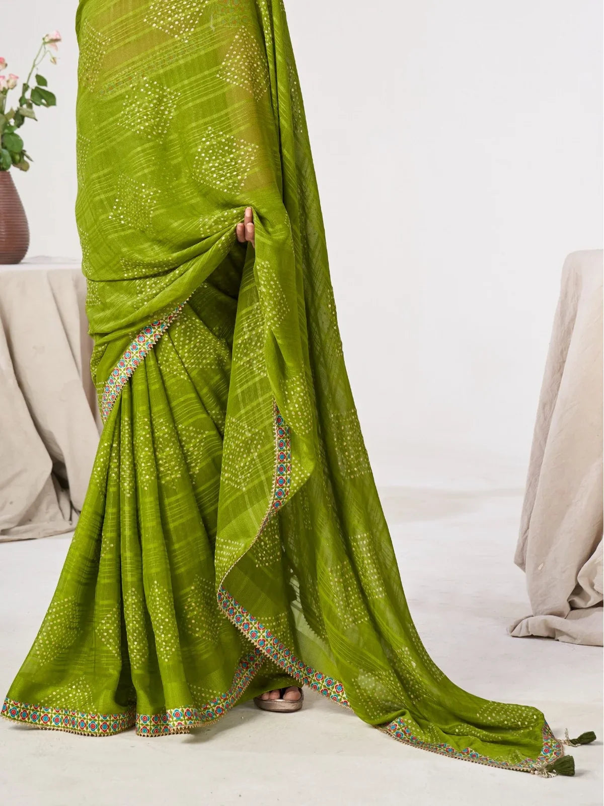 Tarani closeup of premium green georgette saree fabric and detailing