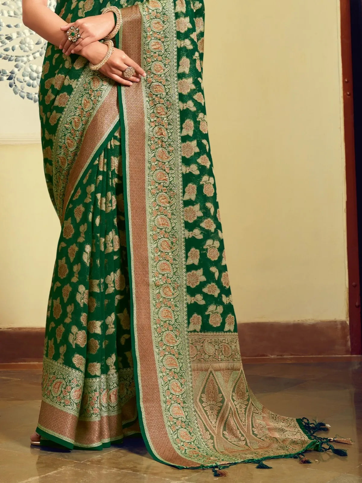 Tarani designer green georgette saree pallu detailed view with rich woven pattern and tassels