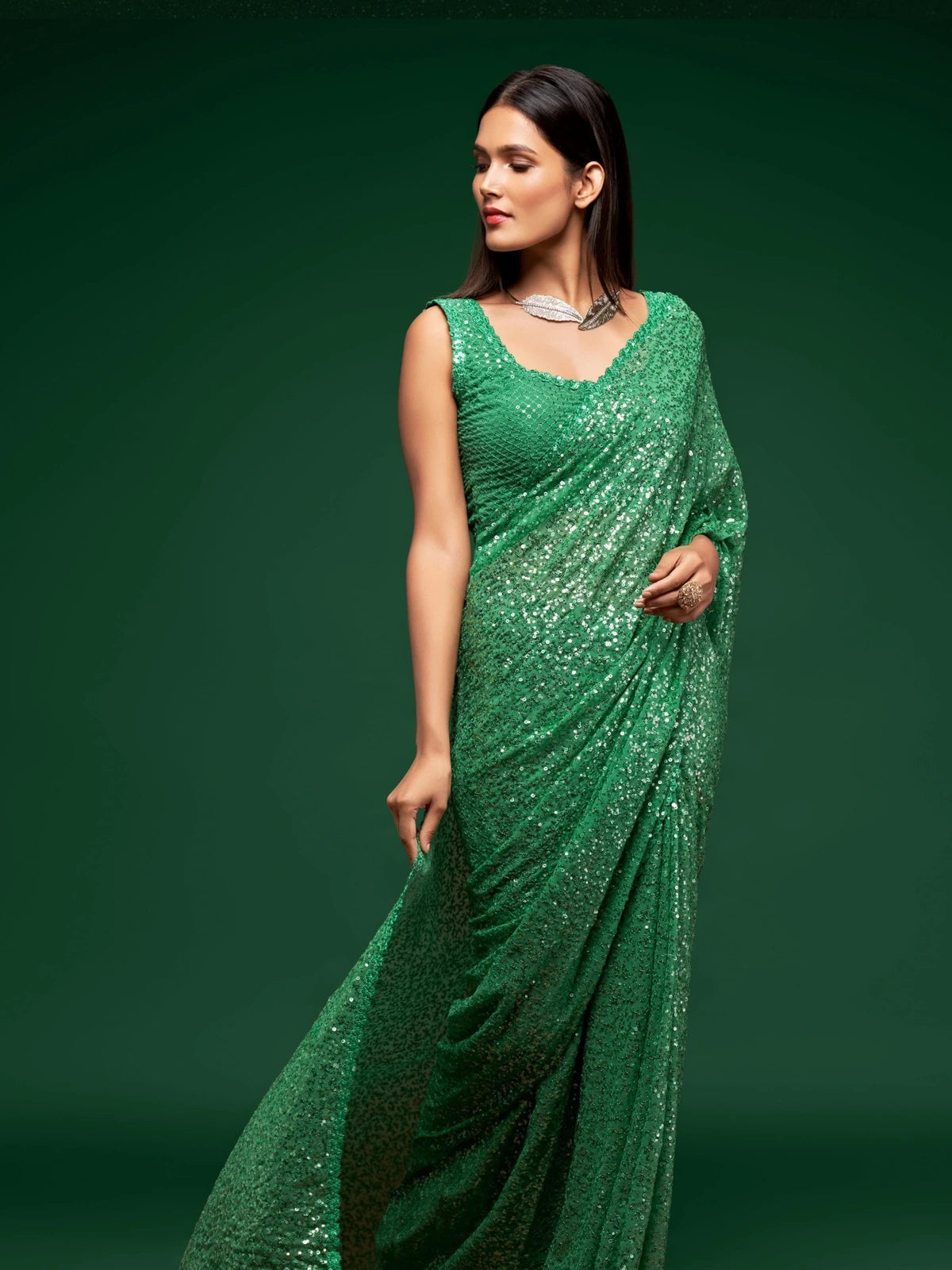 Tarani green party wear georgette saree side pose with shimmering sequins work