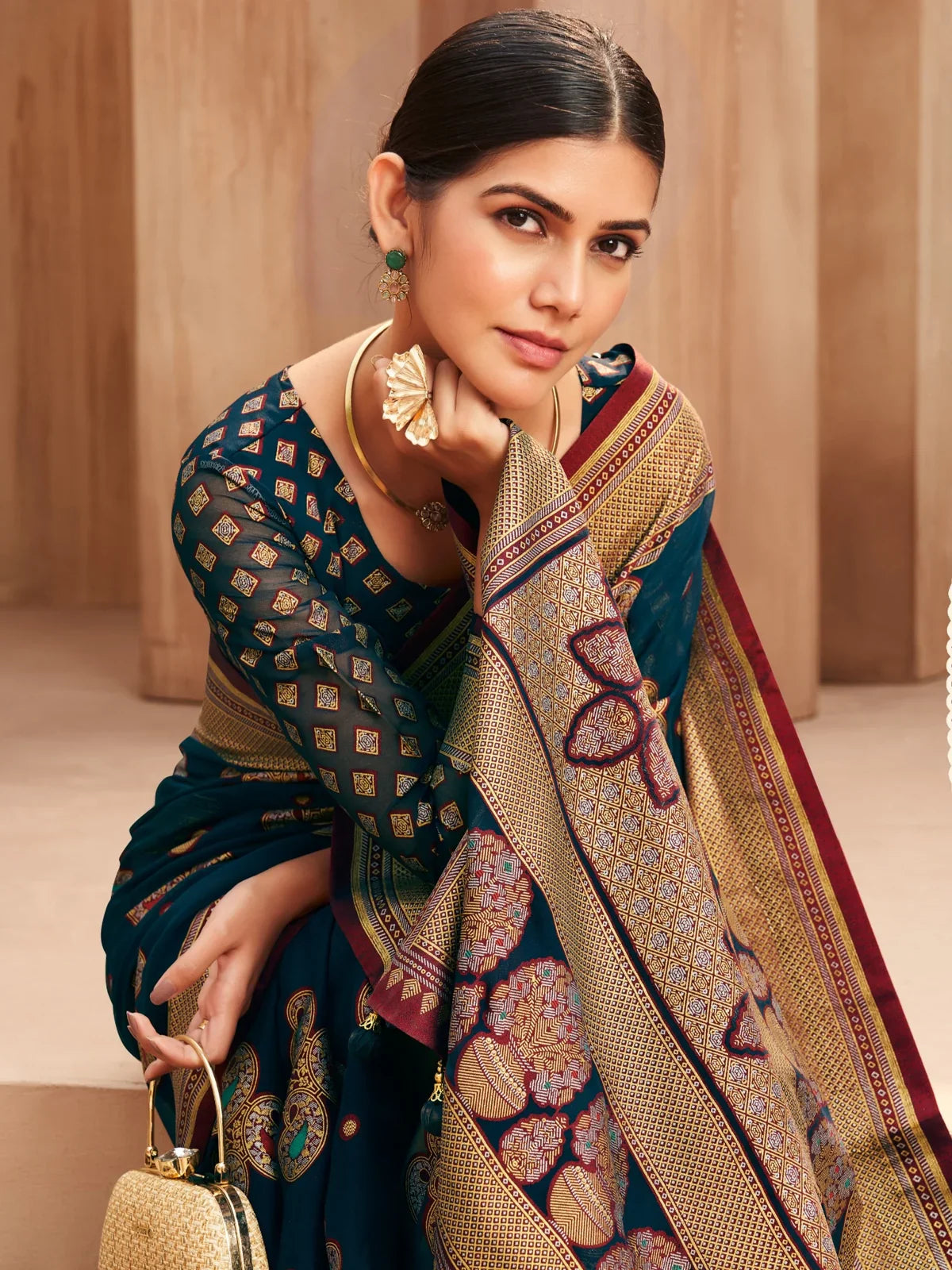 Tarani green georgette saree upper-body pose with woven blouse and earrings