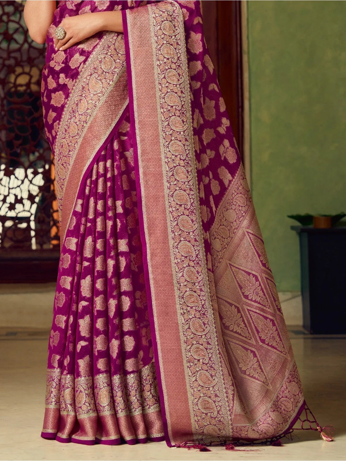 Tarani magenta georgette saree pallu closeup with detailed weaving border and tassels