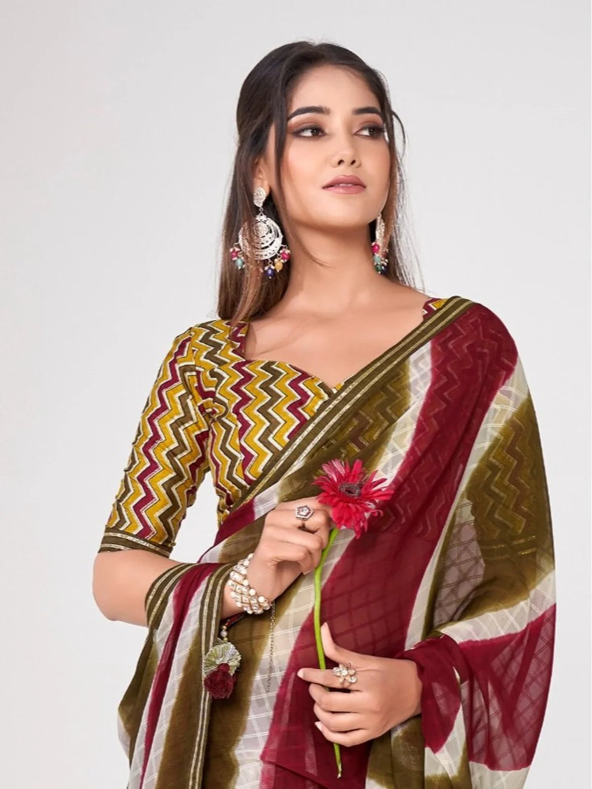 Tarani premium georgette saree upper body view showing detailed blouse and elegant drape in maroon and olive shades