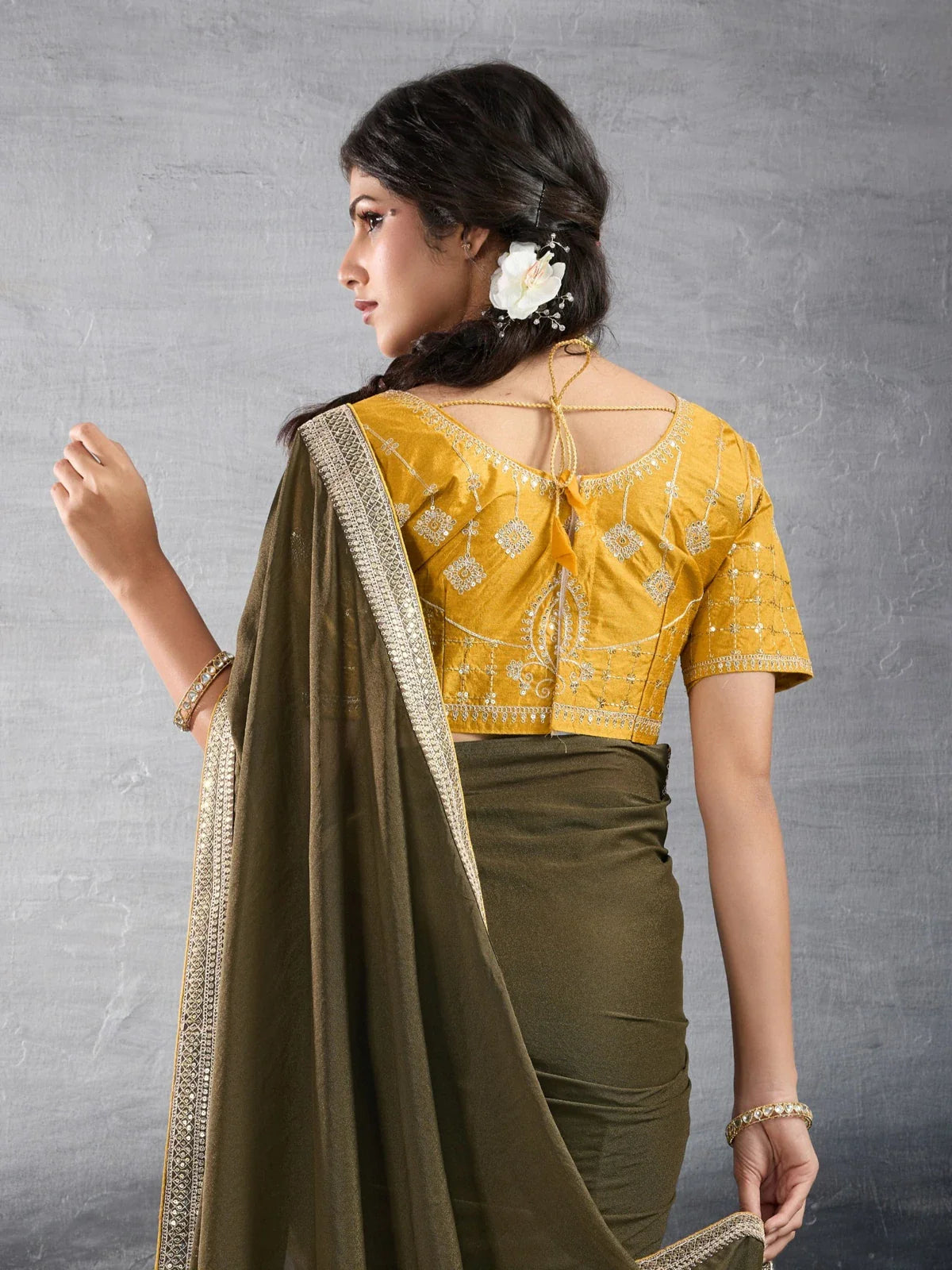 Tarani olive green georgette saree back view highlighting stylish embroidered blouse design