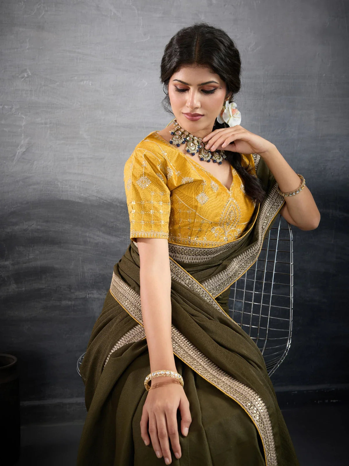 Tarani olive green georgette saree upper body view showing embroidered golden blouse