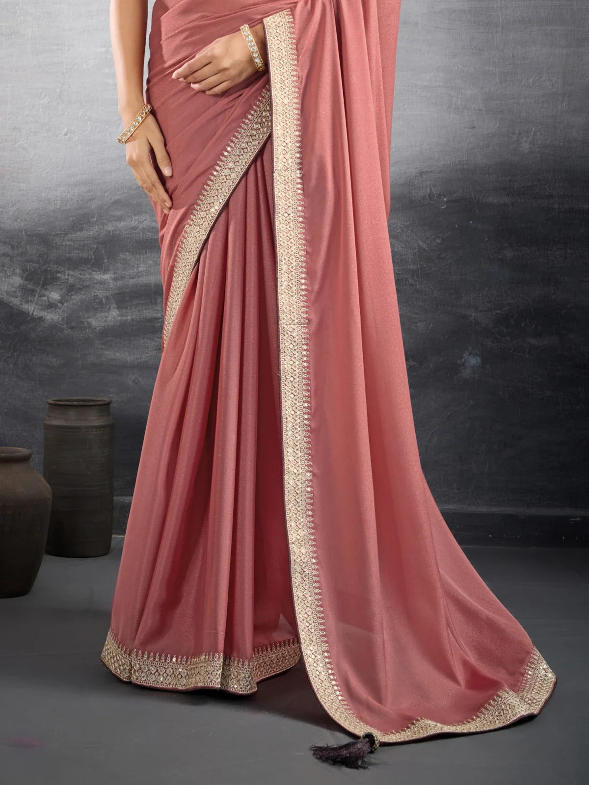 Tarani peach georgette saree closeup view showing elegant border and fabric texture