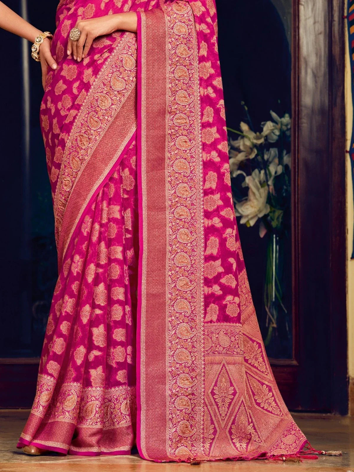 Tarani pink georgette saree pallu close-up showing detailed woven patterns