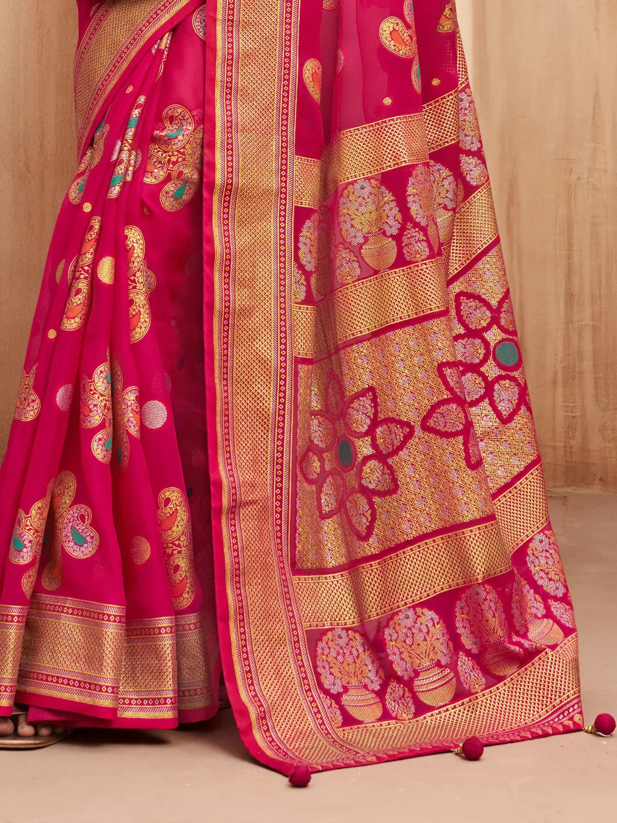 Tarani party wear saree pallu closeup in pink with woven golden motifs and floral patterns