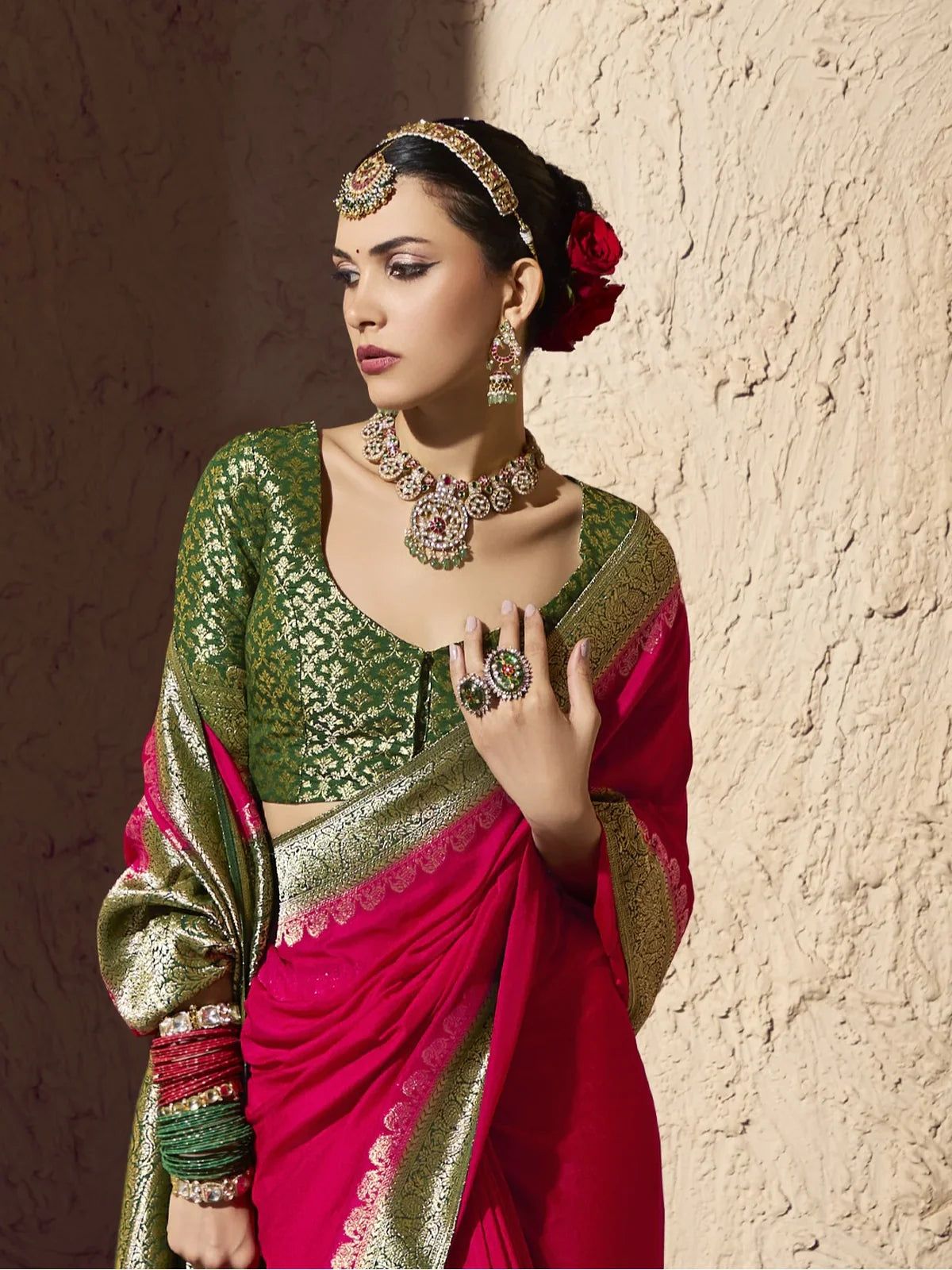 Tarani pink georgette saree upper body view with green woven blouse and elegant jewellery