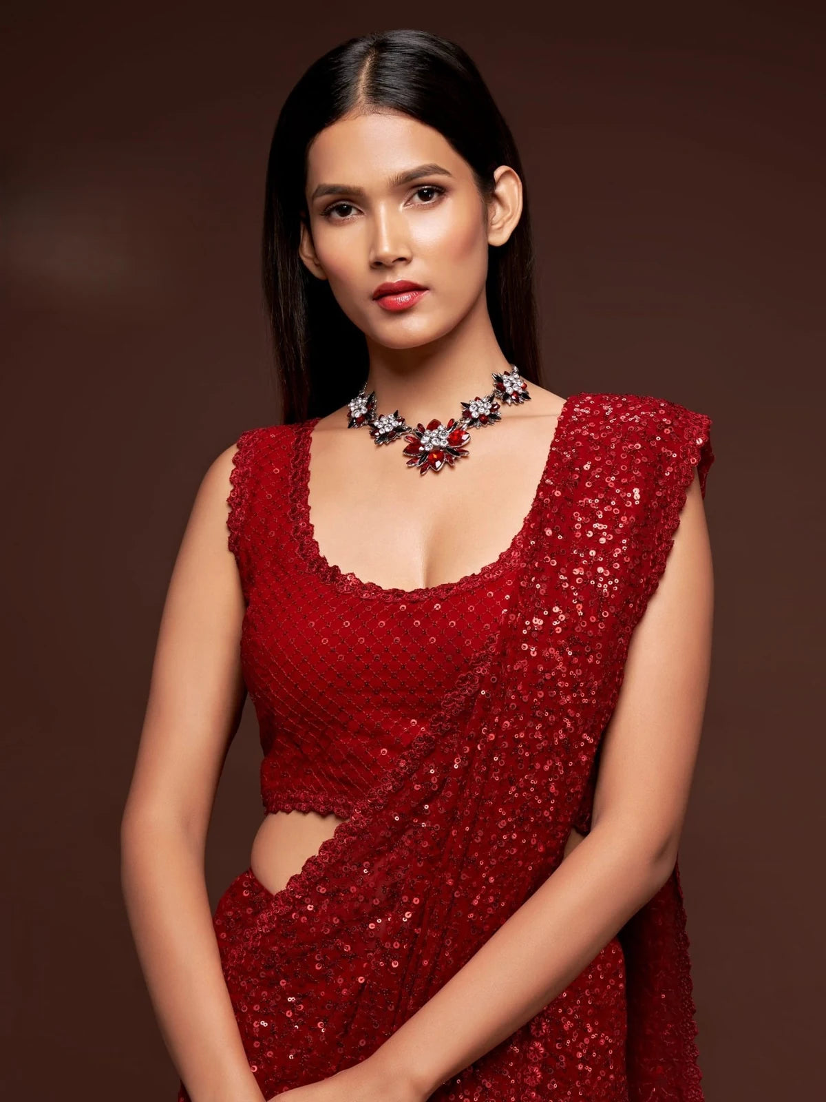 Tarani designer red georgette saree front view with embroidered sleeveless blouse