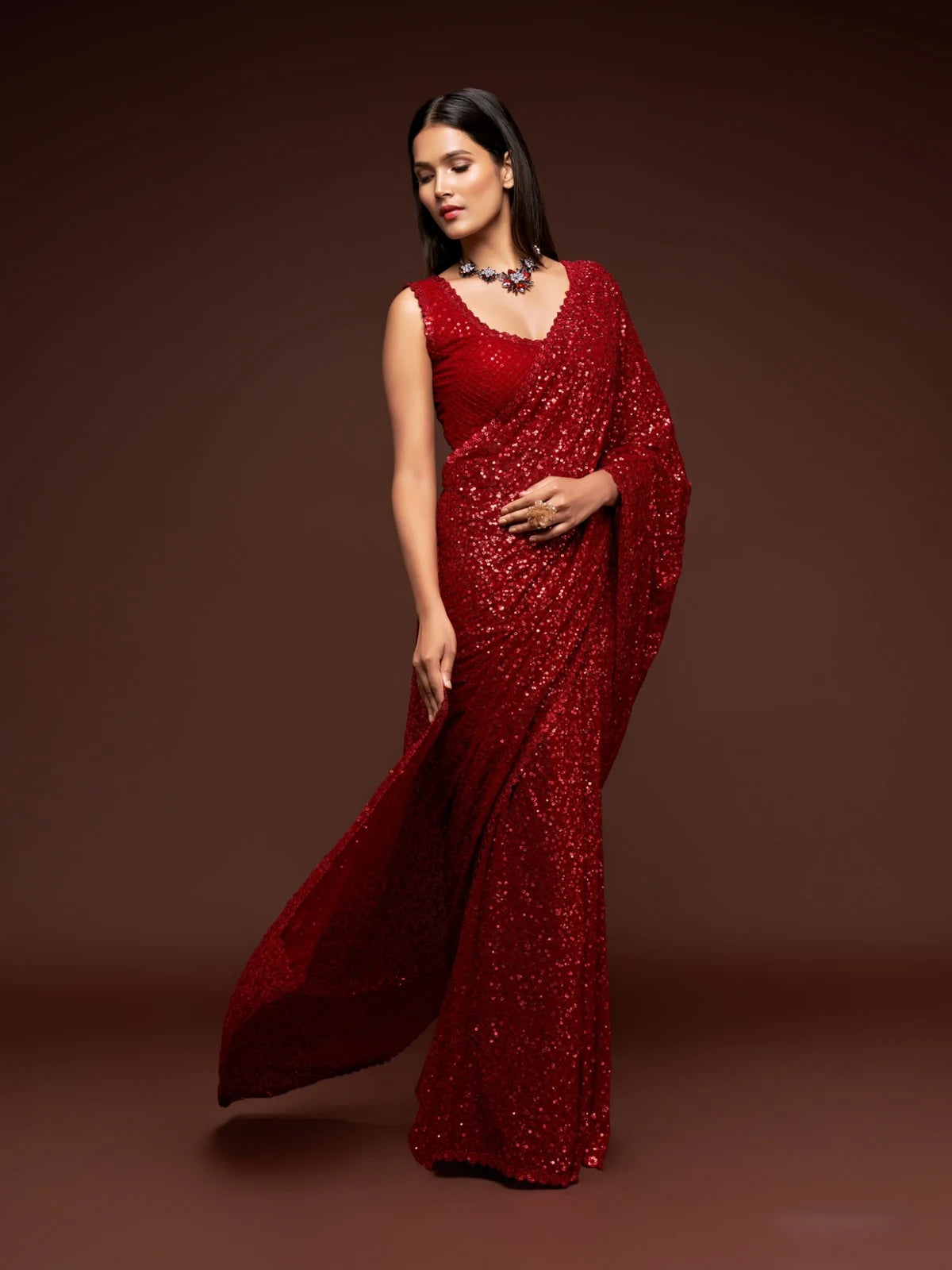 Tarani elegant red georgette party wear saree side pose with shimmering sequins work