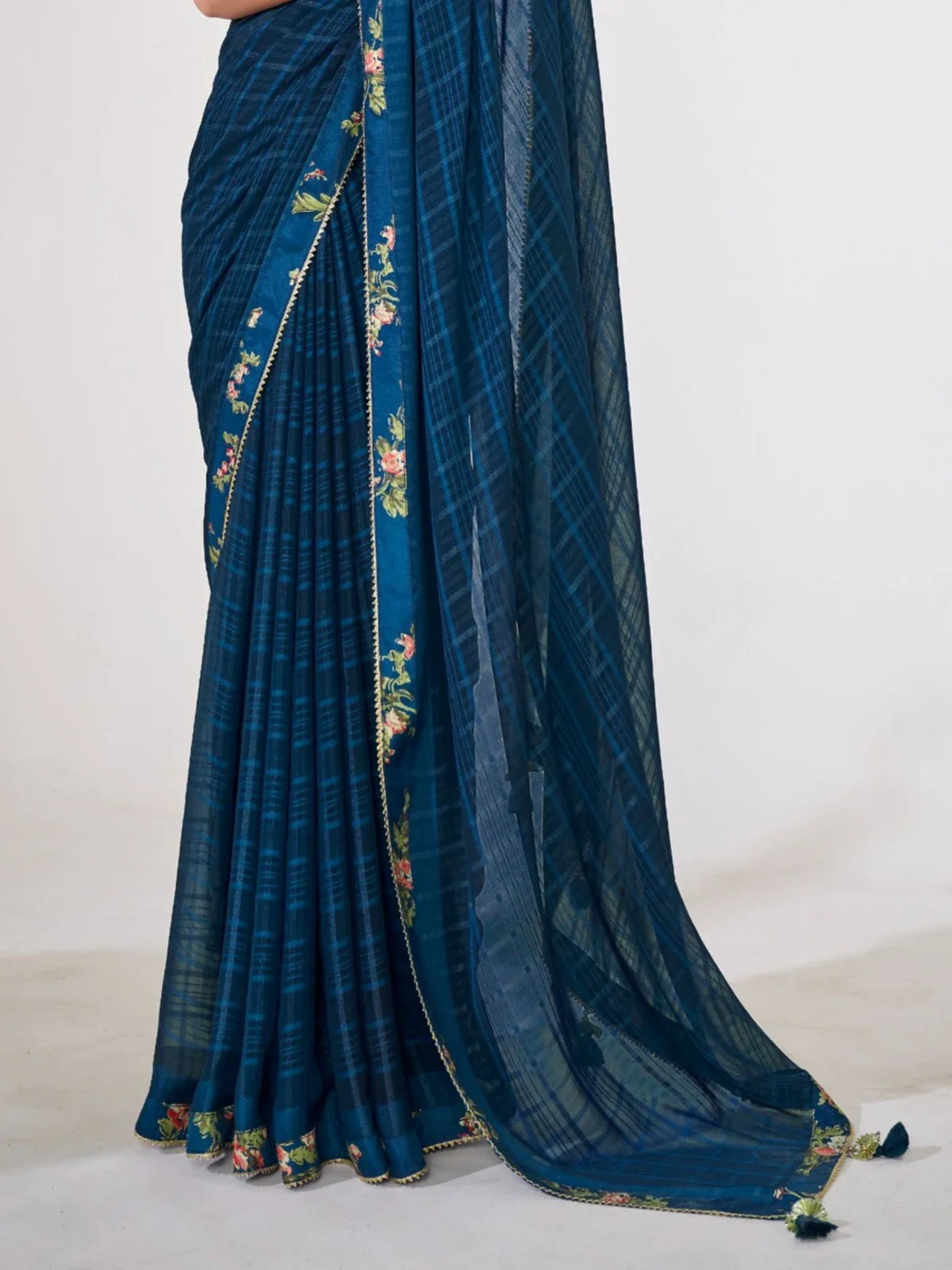 Tarani teal blue georgette saree pallu view showing detailed floral embroidery and tassels