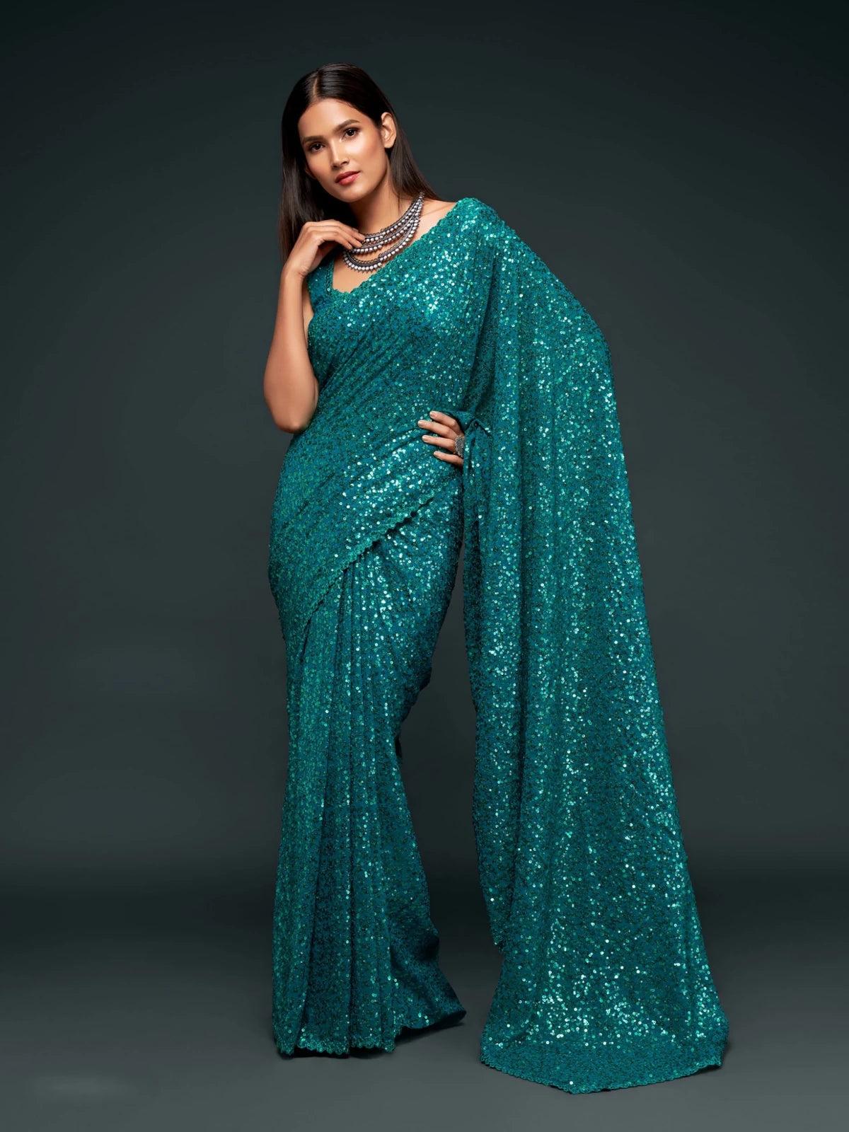 Tarani teal georgette saree front pose with shimmering sequins embroidery for festive styling