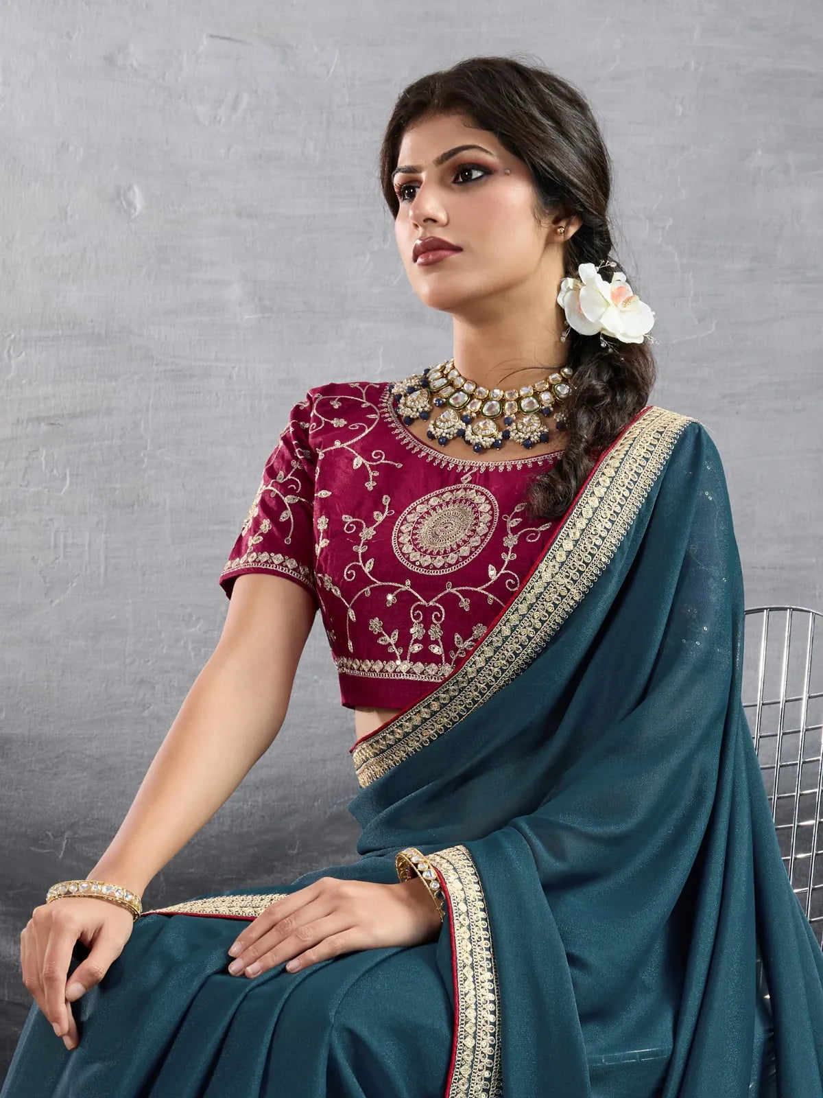 Tarani elegant teal georgette saree upper body view with maroon embroidered blouse
