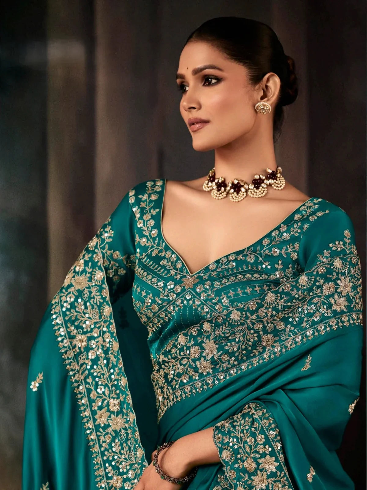 Tarani teal georgette saree upper body close-up showing neckline and sleeve embroidery