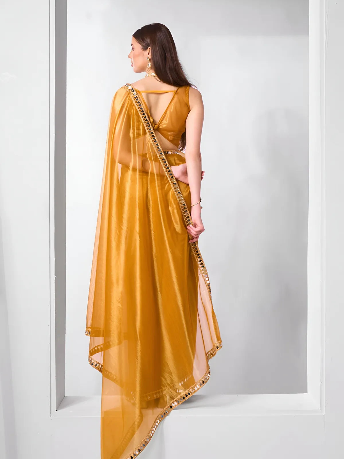 Tarani golden saree with deep back blouse and elegant pallu – back view