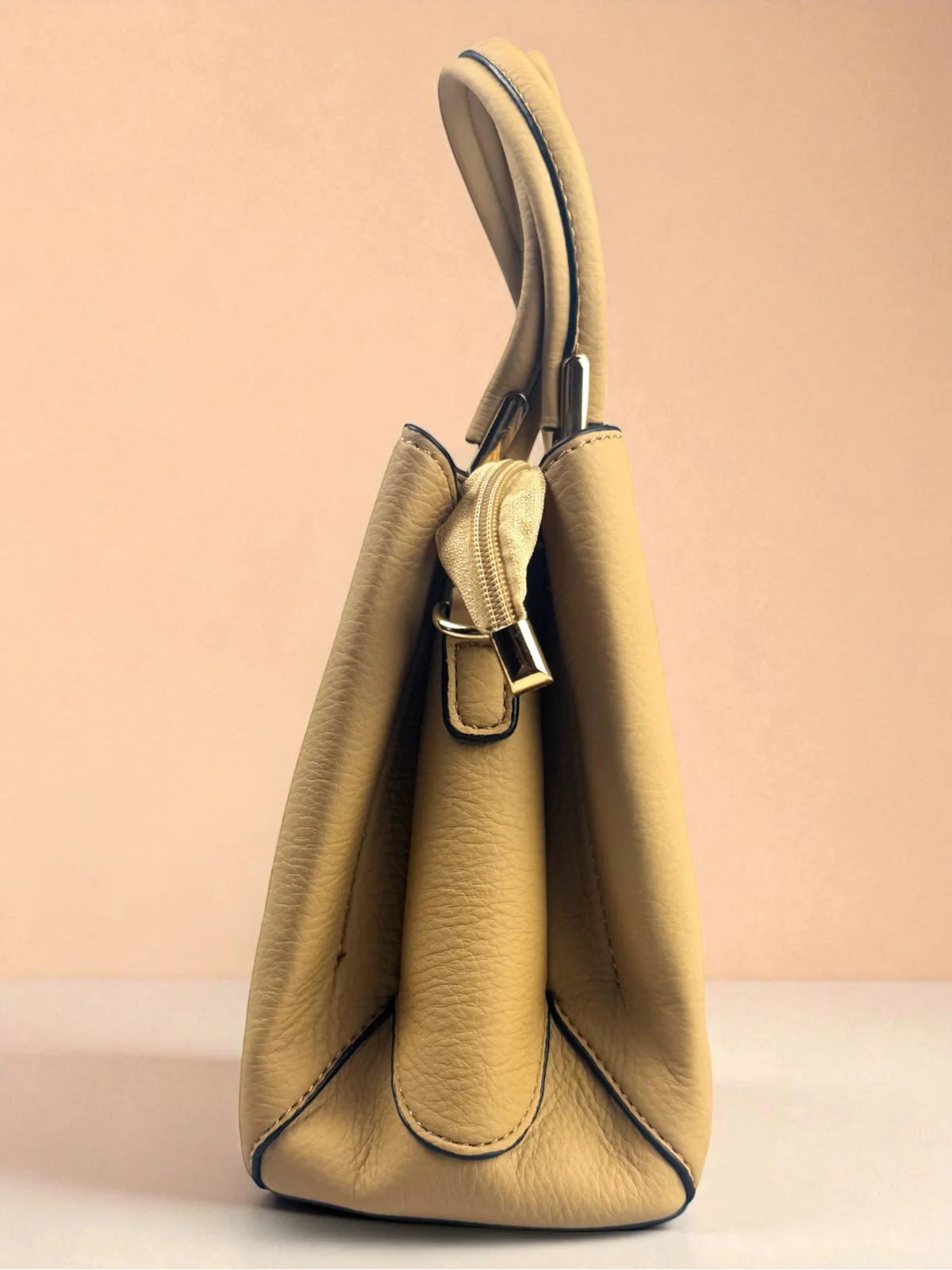 Tarani beige PU leather handbag side profile with handles