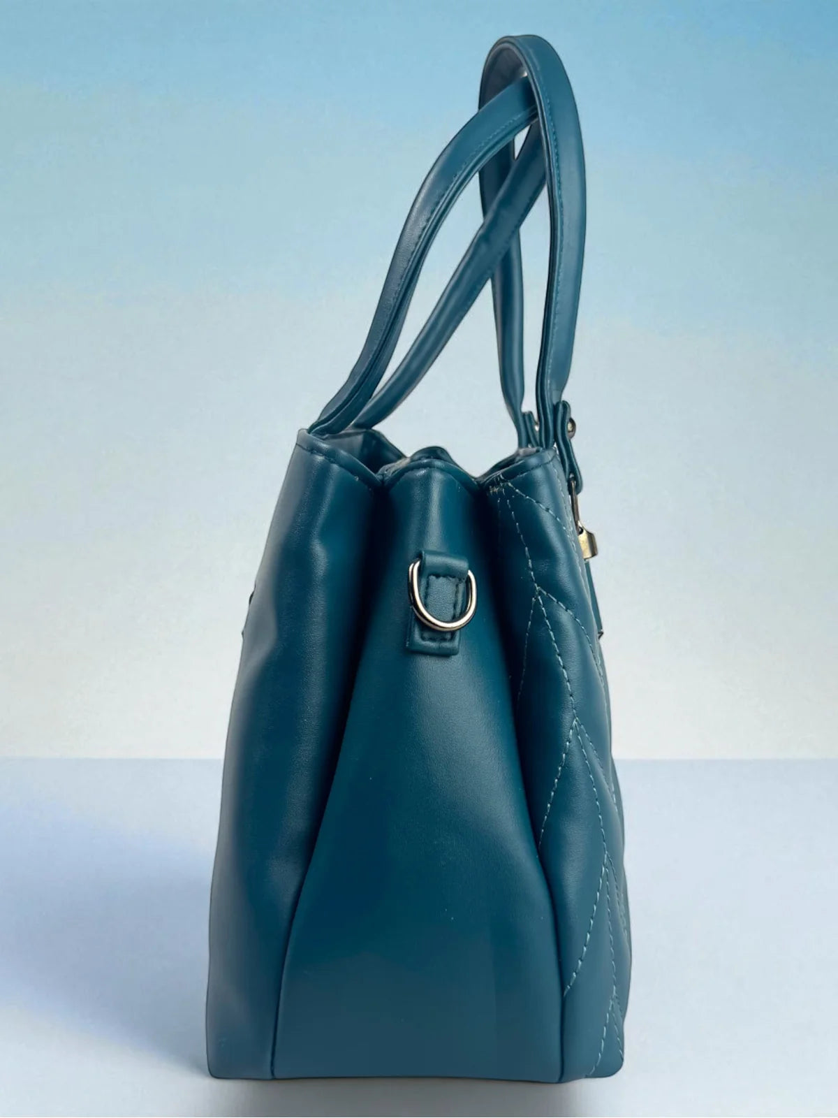 Tarani blue PU leather handbag side view showing depth and elegant shape