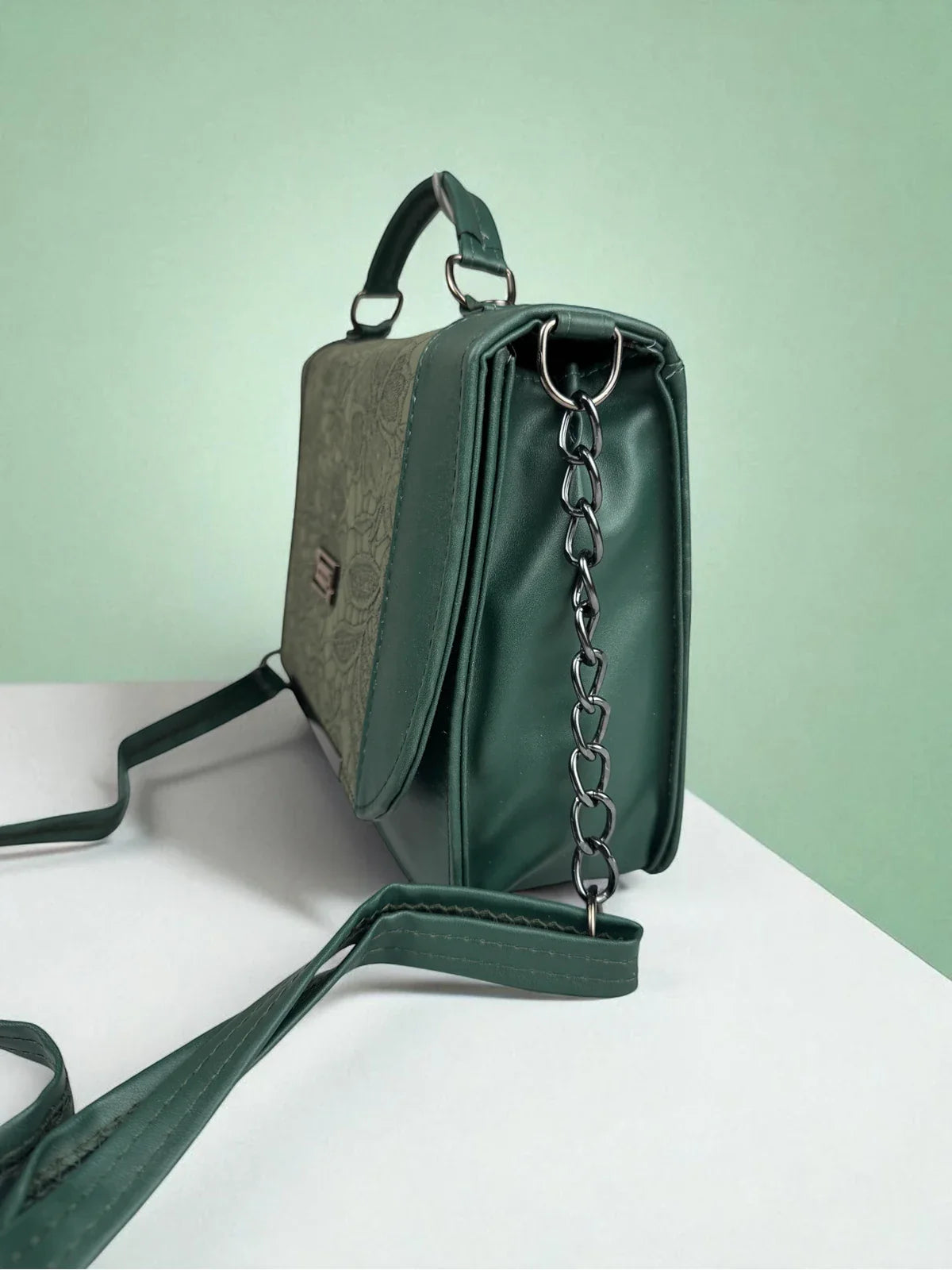 Tarani green PU leather handbag side view with chain detail