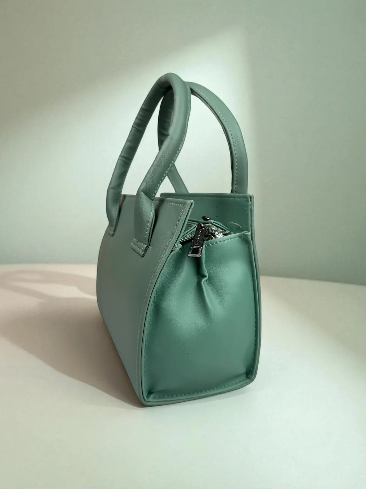 Tarani green PU leather handbag stylish side view with designer handle