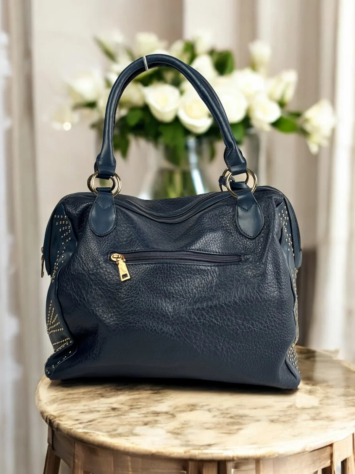 Tarani back view of navy blue PU leather handbag with zipper pocket